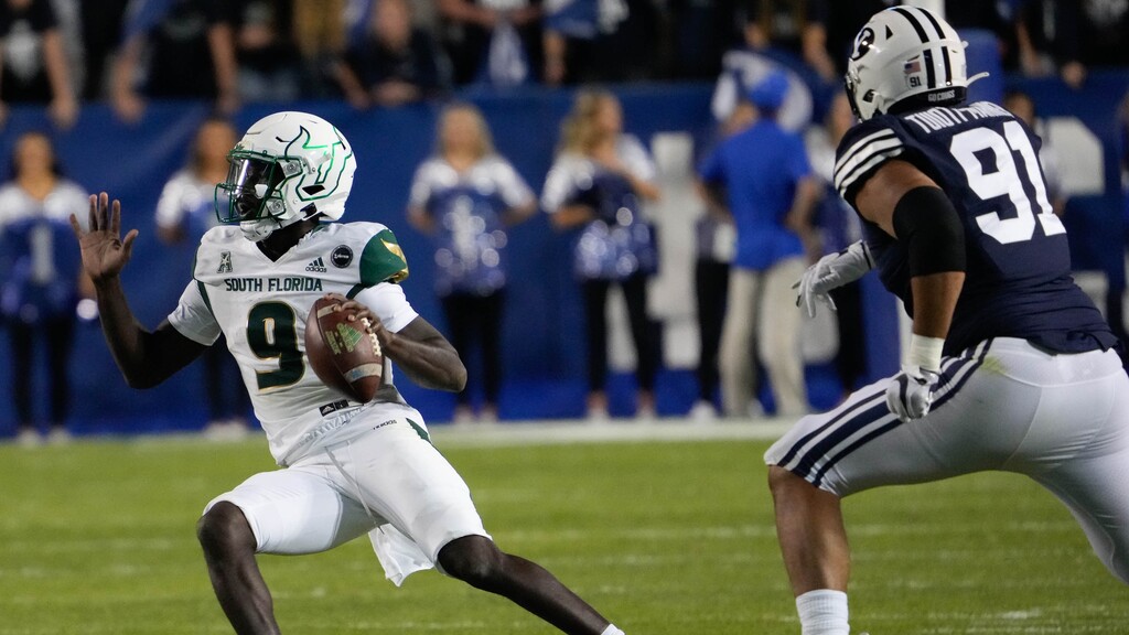 (Francisco Kjolseth | The Salt Lake Tribune) South Florida quarterback Timmy McClain, left scrambles during Saturday's game against BYU  at LaVell Edwards Stadium in Provo, Saturday, Sept. 25, 2021.