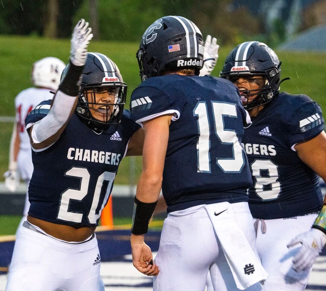 (Rick Egan | The Salt Lake Tribune) Tre Kofe (20) celebrates his touchdown with quarterback Devin Brown (15) in prep football action between Corner Canyon Chargers and the East Leopards, on Saturday, Aug. 21, 2021.