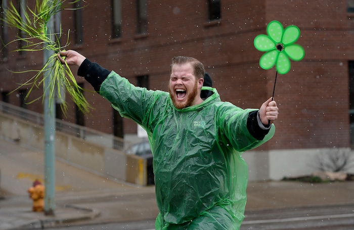 (Scott Sommerdorf | The Salt Lake Tribune) Jackson Carter of FM 105.1 marches in the 40th annual Salt Lake City St. Patrick's Day Parade on Saturday, March 17, 2018.