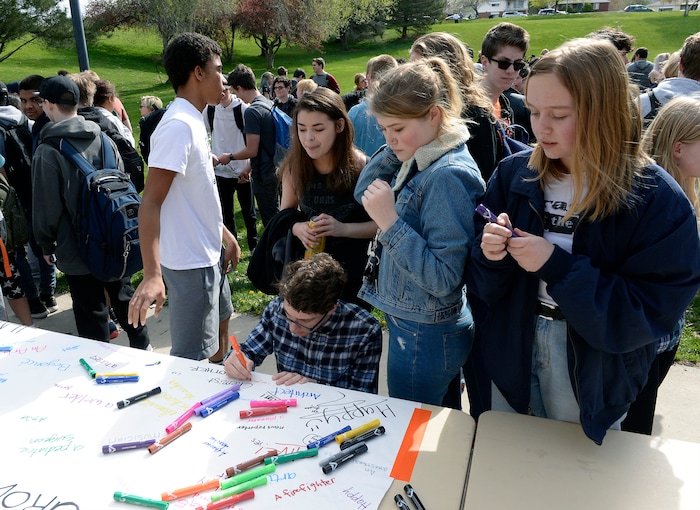 (Al Hartmann  |  The Salt Lake Tribune) 	
Highland High School students sign a poster that said "When I grow up I want to be...."  Over one hundred students at Highland High School staged a walkout Friday April 20, 2018 in honor of the anniversary of the Columbine High School massacre. Demonstrators walked from the school to Sugar House Park where they made posters, wrote letters to their congressmen and listened to speakers. 