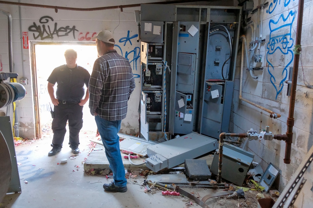 (Leah Hogsten  |  The Salt Lake Tribune) Security guard Nathan Lancaster talks with JP Goates, the city's captial asset manager, Oct. 29, 2020. In the 1980's Raging Waters water park was home to the world's third wave pool. Today the property is in such disrepair that Salt Lake City needs to disassemble it and figure out some kind of new park to replace it. Closed since 2018,vandalism and operator abandonment has left the park a liability for the city.