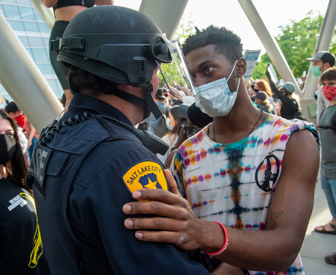 (Rick Egan  |  The Salt Lake Tribune) Henry Kemp hugs a Salt Lake City Police officer at the Public Safety Building during a demonstration on Monday, June 1, 2020.
