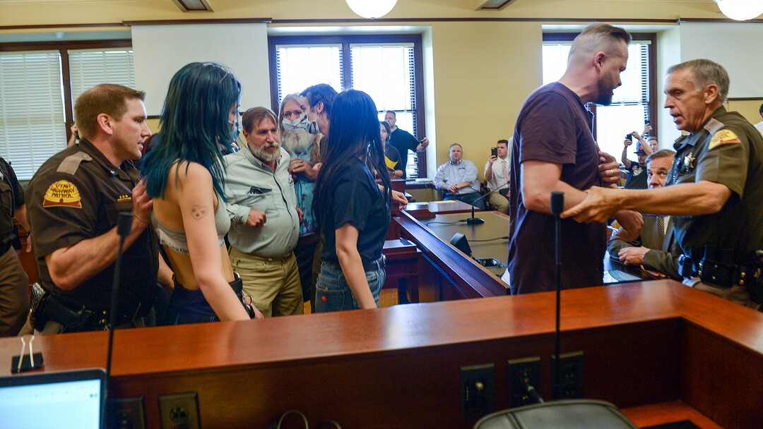 (Leah Hogsten  |  The Salt Lake Tribune) Opponents of the proposed inland port are escorted out of the Utah Inland Port Authority Board meeting by Utah Highway Patrol officers at the Capitol, June 5, 2019. The Inland Port Authority Board had to cancel its meeting last month after a group of protesters took over the meeting.