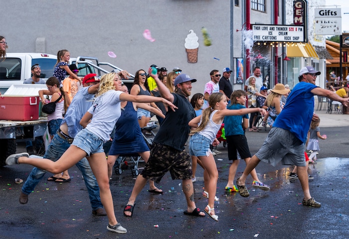 (Rick Egan | The Salt Lake Tribune) 
Parade goers hurl water balloons at one of the fire trucks in the Pioneer Day Parade in Panguitch, on Saturday, July 23, 2022.