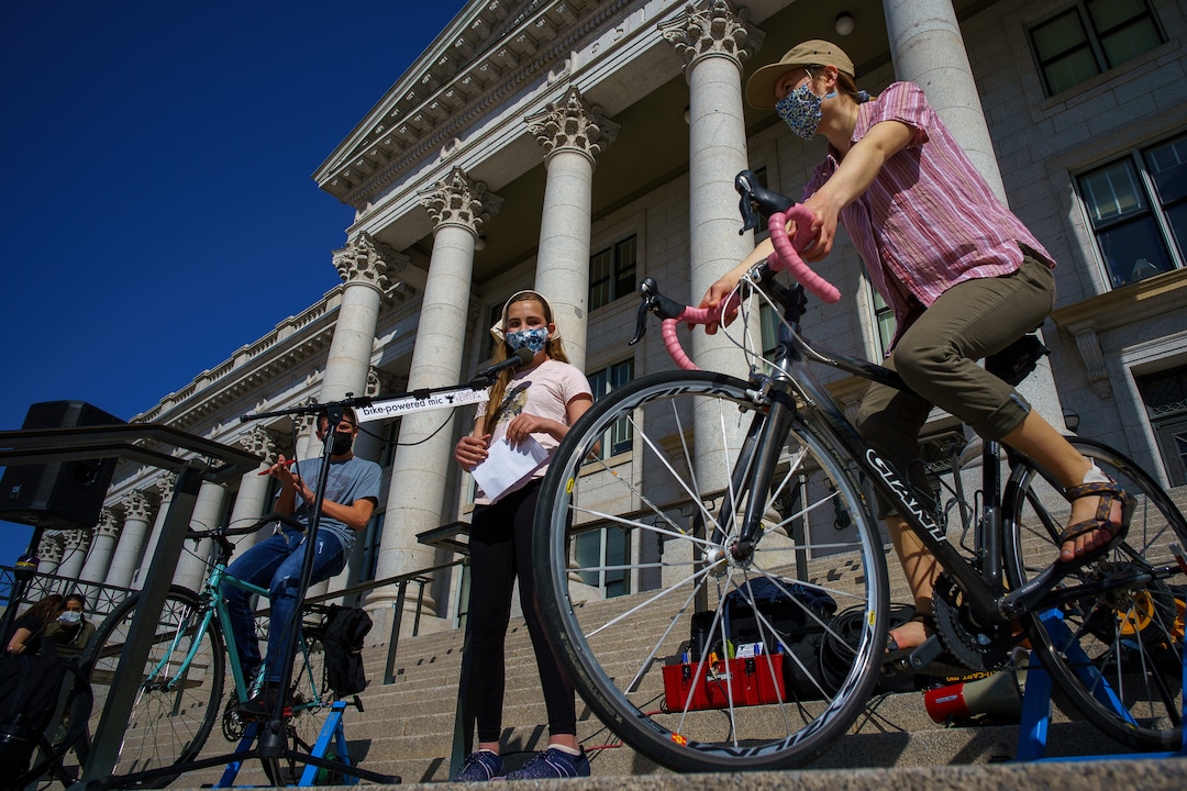 (Trent Nelson  |  The Salt Lake Tribune) Melanie Van Hook speaks on a bike-powered microphone as students gather at the state Capitol in Salt Lake Cityto protest inaction on the climate crisis on Friday, March 19, 2021.