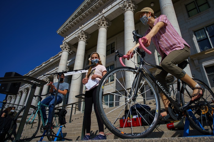 (Trent Nelson | The Salt Lake Tribune) Melanie Van Hook speaks on a bike-powered microphone as students gather at the state Capitol in Salt Lake Cityto protest inaction on the climate crisis on Friday, March 19, 2021.