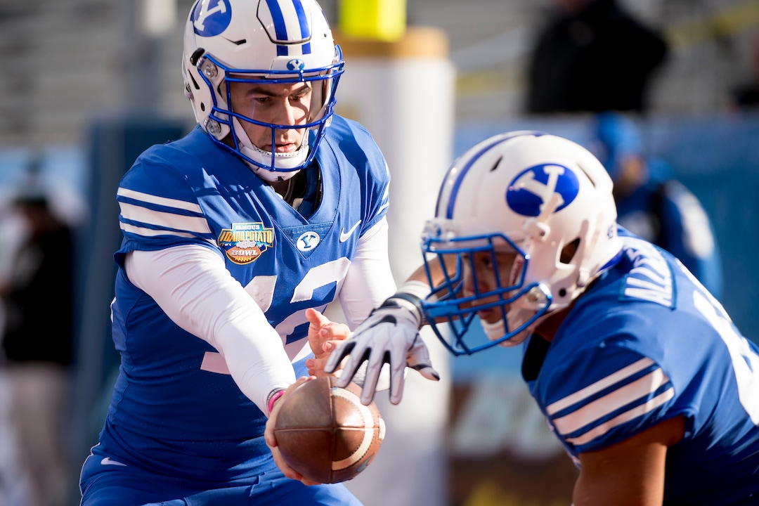 (Jeremy Harmon  |  The Salt Lake Tribune) Brigham Young Cougars quarterback Tanner Mangum (12) and Brigham Young Cougars running back Tyler Allgeier (45) warm up as BYU gets ready to face the Western Michigan Broncos in the Famous Idaho Potato Bowl in Boise, Idaho, on Friday, Dec. 21, 2018.