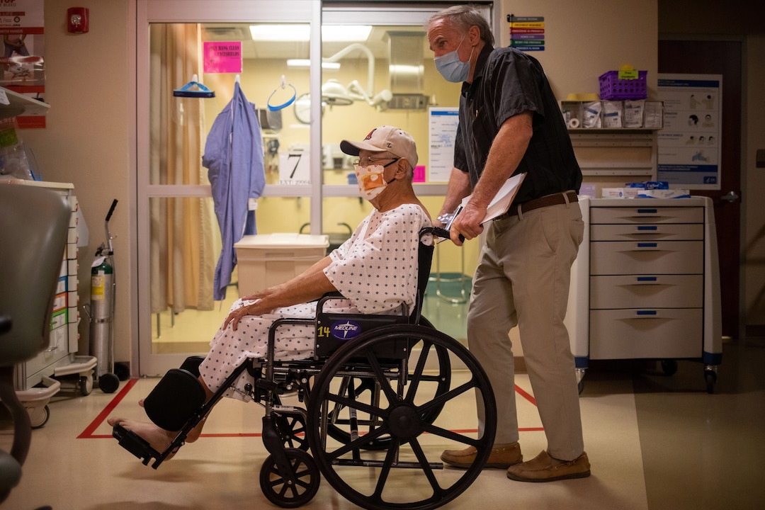 (Sharon Chischilly | The New York Times) Frank Armao, the chief medical officer at the Winslow Indian Health Care Center, with a patient at the hospital in Winslow, Ariz., on Aug. 25, 2020. Thirty-two COVID-19 patients have died there.