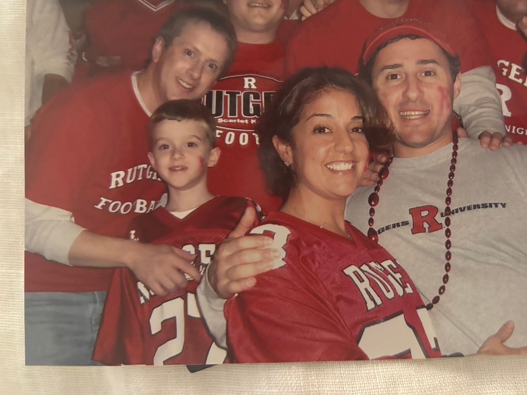 (Kevin Reynolds) A young Kevin Reynolds attends a Rutgers game with his dad, to the left, with a group of fans.