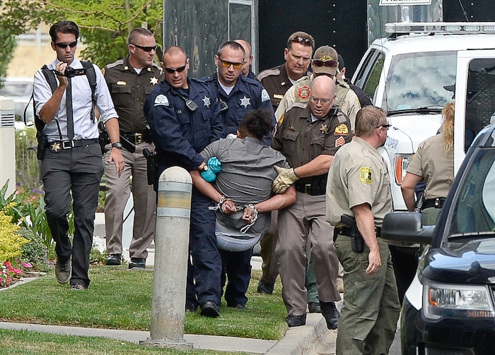 (Francisco Kjolseth  |  The Salt Lake Tribune)  Activists are removed from a building where they staged a protest against a private prison company with contracts to hold undocumented immigrants on Thursday, July 12, 2018, at the headquarters of Management and Training Corporation in Centerville.