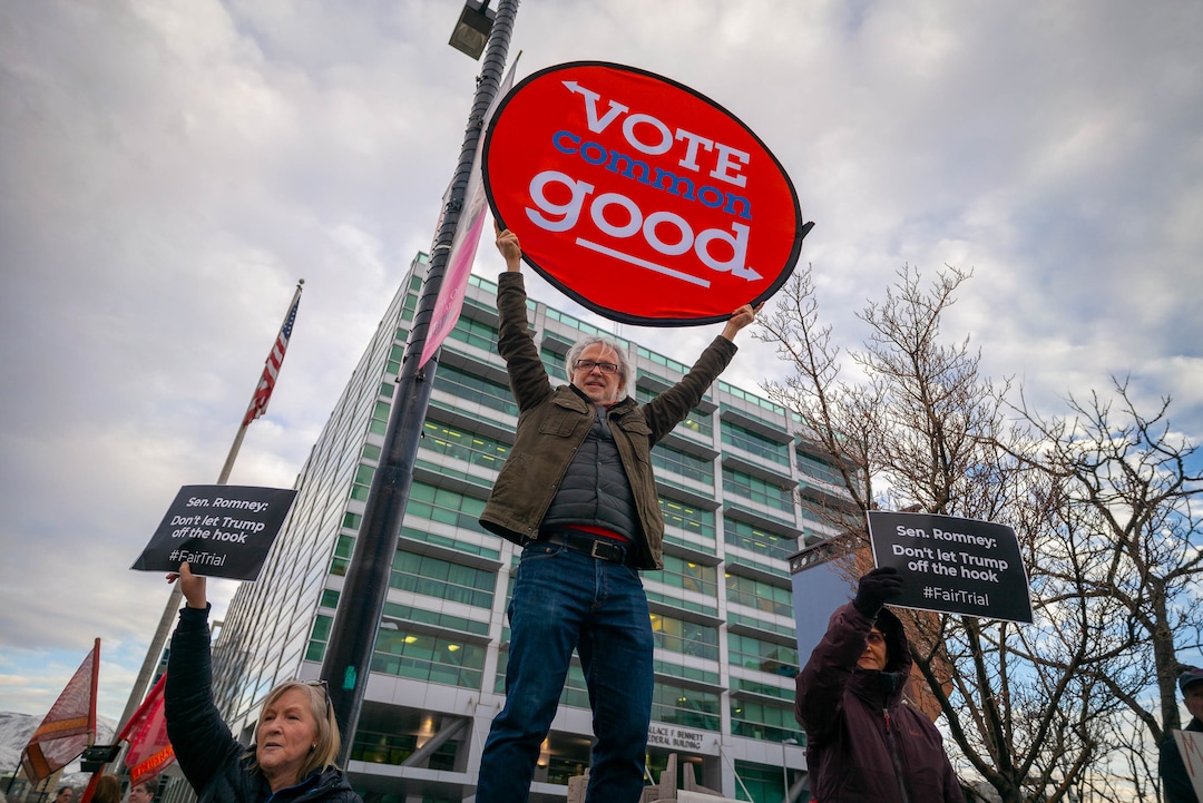 (Trent Nelson  |  The Salt Lake Tribune) Samir Selmanovic, center, holds a sign as a coalition of progressive groups gathered Thursday outside the federal building in Salt Lake City on Thursday, Jan. 16, 2020 to push for a fair and impartial Senate impeachment hearing against President Donald Trump.