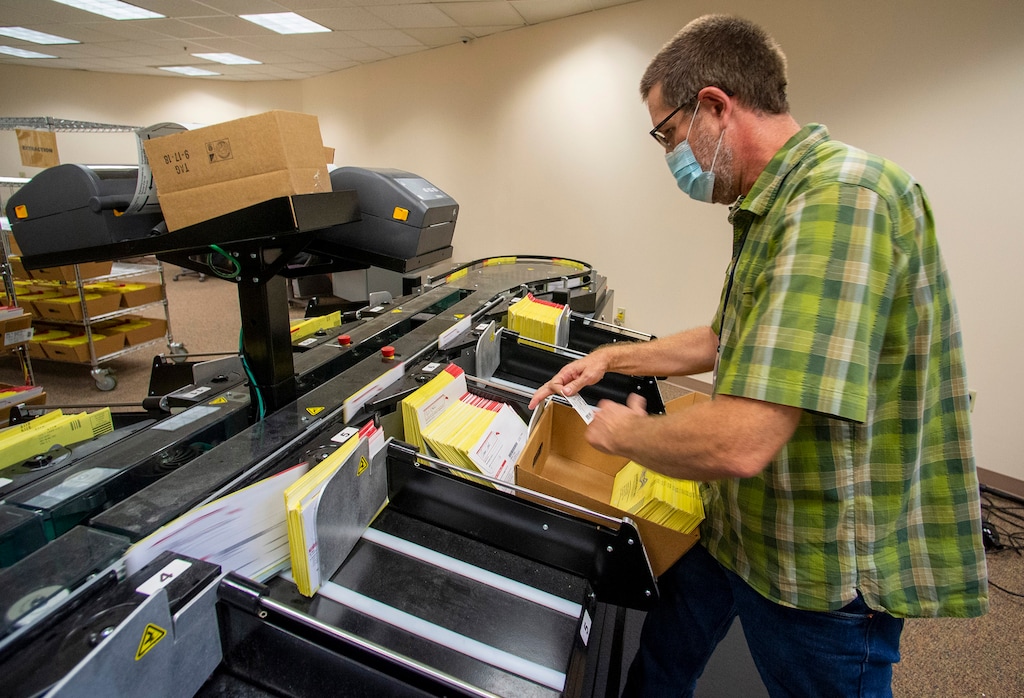 (Rick Egan  |  Tribune file photo)   Bret Chappell prepares primary election ballots for counting at the Salt Lake County Government Center on Wednesday July 1, 2020.