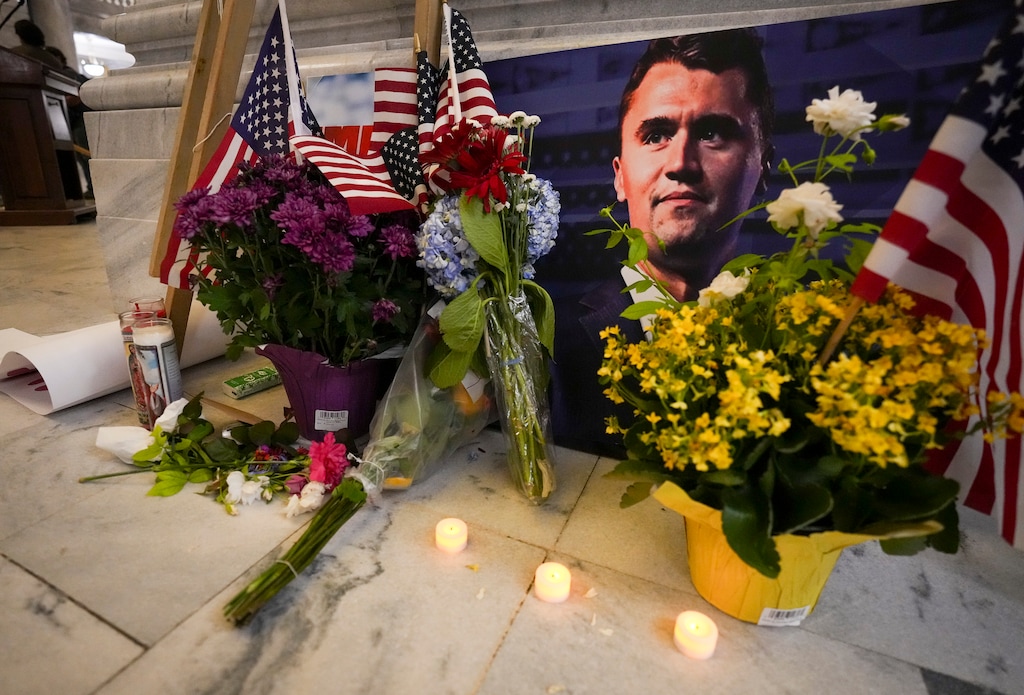 (Bethany Baker | The Salt Lake Tribune) Flowers, American flags and candles are seen beside a photo of Charlie Kirk following a vigil at the Utah Capitol in Salt Lake City following the shooting death of the conservative activist at Utah Valley University on Wednesday, Sept. 10, 2025.