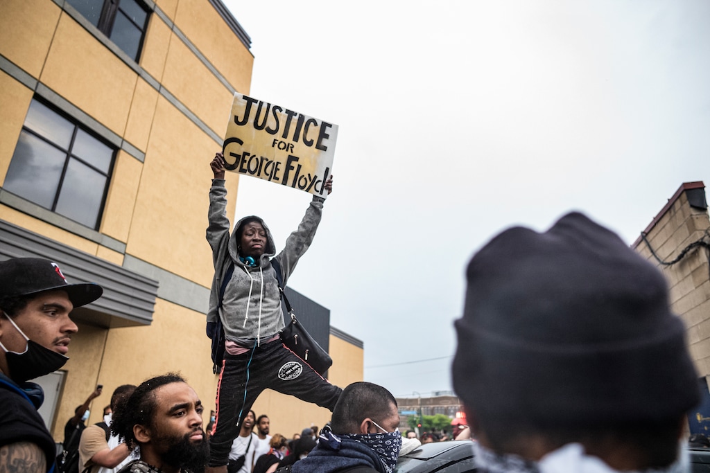 Protesters gather near the Minnesota Police 3rd Precinct during a gathering Tuesday, May 26, 2020, in response to the death the day before of George Floyd in police custody. Four Minneapolis officers involved in the arrest of Floyd, a black man who died in police custody, were fired Tuesday, hours after a bystander’s video showed an officer kneeling on the handcuffed man’s neck, even after he pleaded that he could not breathe and stopped moving. (Richard Tsong-Taatarii/Star Tribune via AP)