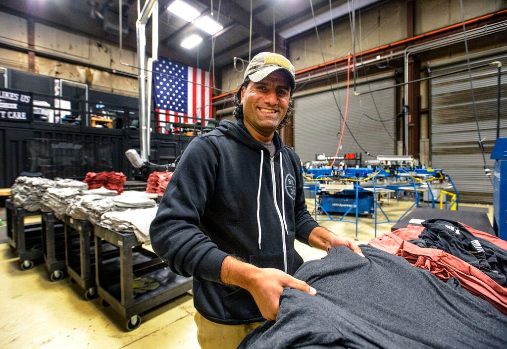 (Steve Griffin  |  The Salt Lake Tribune)   Mohammad "Wali" Tasleem prepares shirts for screening at Black Rifle Coffee Co. in Salt Lake City Tuesday March 20, 2018. Tasleem is an Afghan refugee who worked with U.S. Special Forces in Afghanistan. He had to leave his native country or be killed. Now he works with a former friend and U.S. soldier Jeff Kirkham who helped bring Wali to Utah.