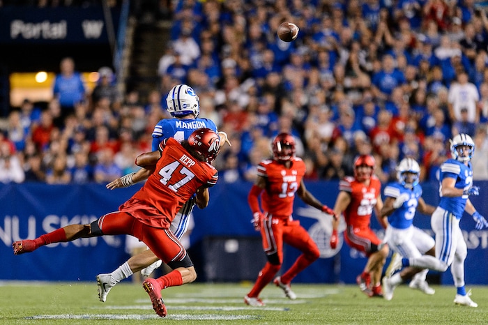 (Trent Nelson | The Salt Lake Tribune)  Utah Utes defensive end Caleb Repp (47) takes down Brigham Young Cougars quarterback Tanner Mangum (12), who throws a near-interception as BYU hosts Utah, NCAA football in Provo, Saturday September 9, 2017.