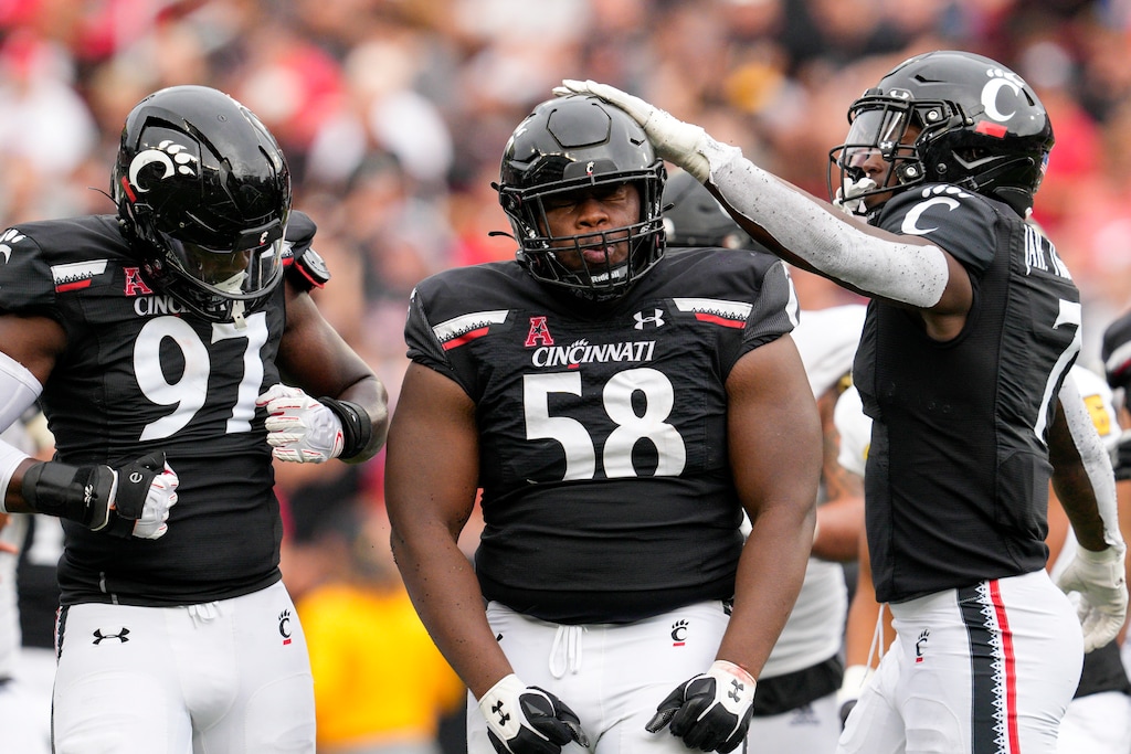 (Jeff Dean | AP) Cincinnati defensive lineman Dontay Corleone (58) celebrates with teammates after tackling Kennesaw State running back Jordan Lay for a loss during the second half of a game last season. Corleone was named to The Associated Press preseason All-America team this year.