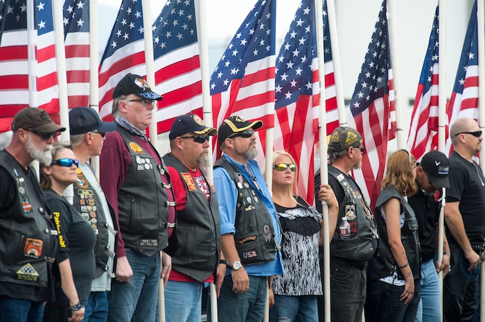 (Rick Egan  |  The Salt Lake Tribune)     The Patriot Guard Riders of Utah, hold flags as they await the remains of Marine Pfc. Robert K. Holmes at Delta Air Cargo. Holmes died aboard the USS Oklahoma during the attack on Pearl Harbor. Friday, Aug. 17, 2018.