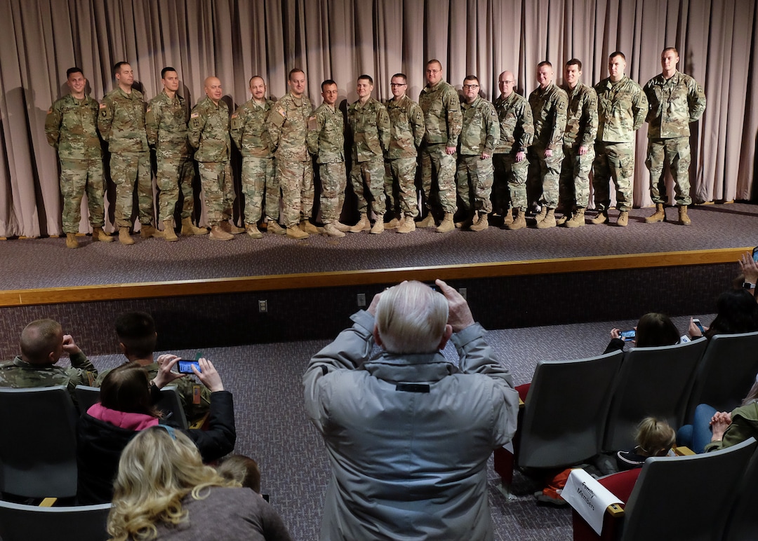 (Francisco Kjolseth  |  The Salt Lake Tribune)  Men from the 141st Military Intelligence Battalion gather for photos by family members during departure ceremonies at the Utah National Guard headquarters in Draper on Monday, March 19, 2018, before a tour of Kuwait. 