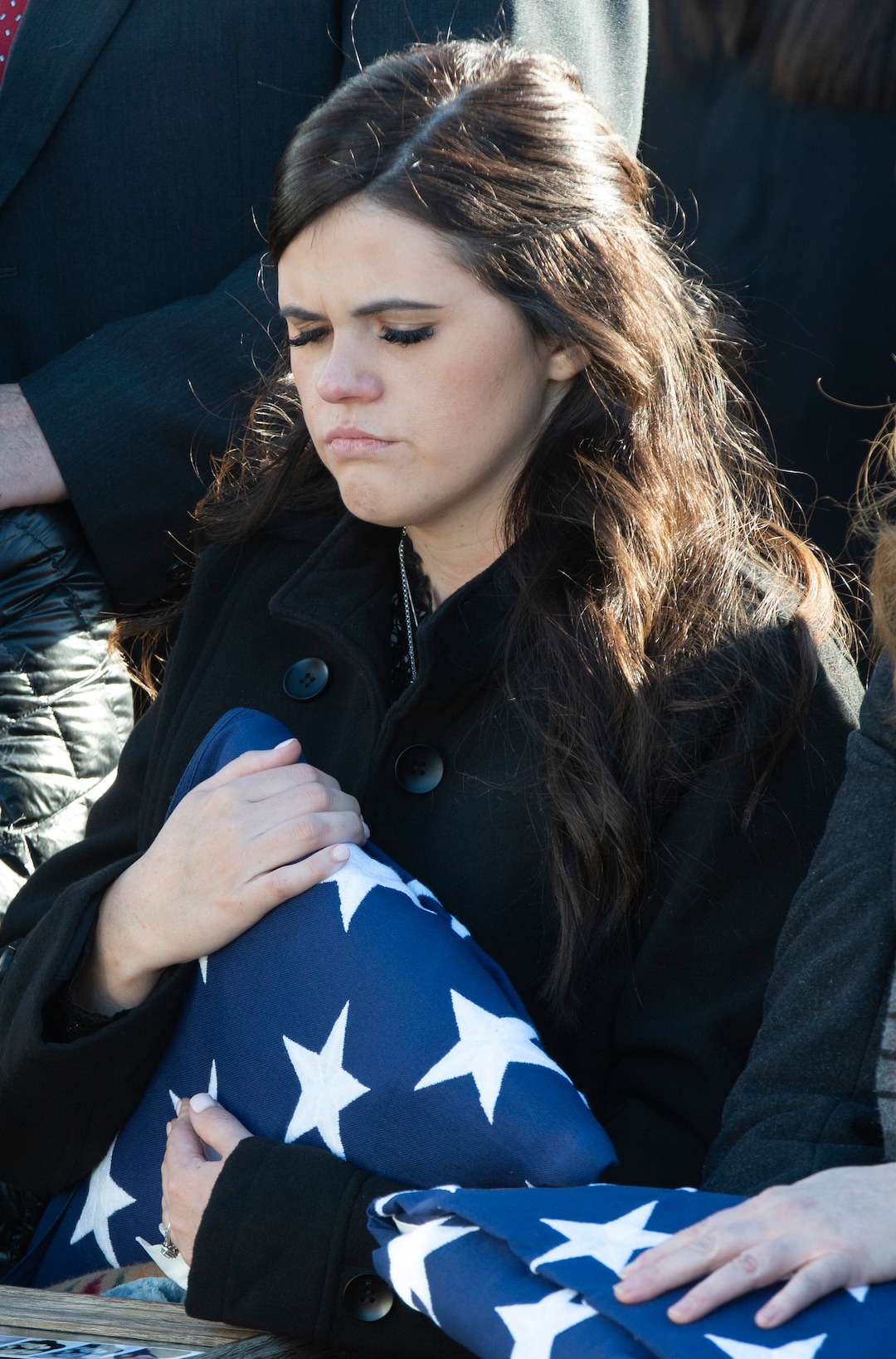 (Rick Egan  |  The Salt Lake Tribune)   McKenzie Fuchigami, holds the flag from her husbands casket  during the graveside service for her husband Kirk T. Fuchigami Jr. in the Brigham City Cemetery,  Monday, Dec. 9, 2019.