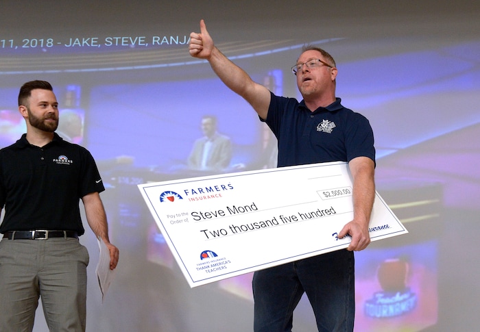(Scott Sommerdorf | The Salt Lake Tribune)
Real Salt Lake Academy math teacher Steve Mond reacts after accepting a $2,500 check from Farmer's Insurance agent Mikkel Chadburn during the watch party at the school, Friday, May 11, 2018, as they showed Mond's performance in the JEOPARDY! Teachers Tournament.