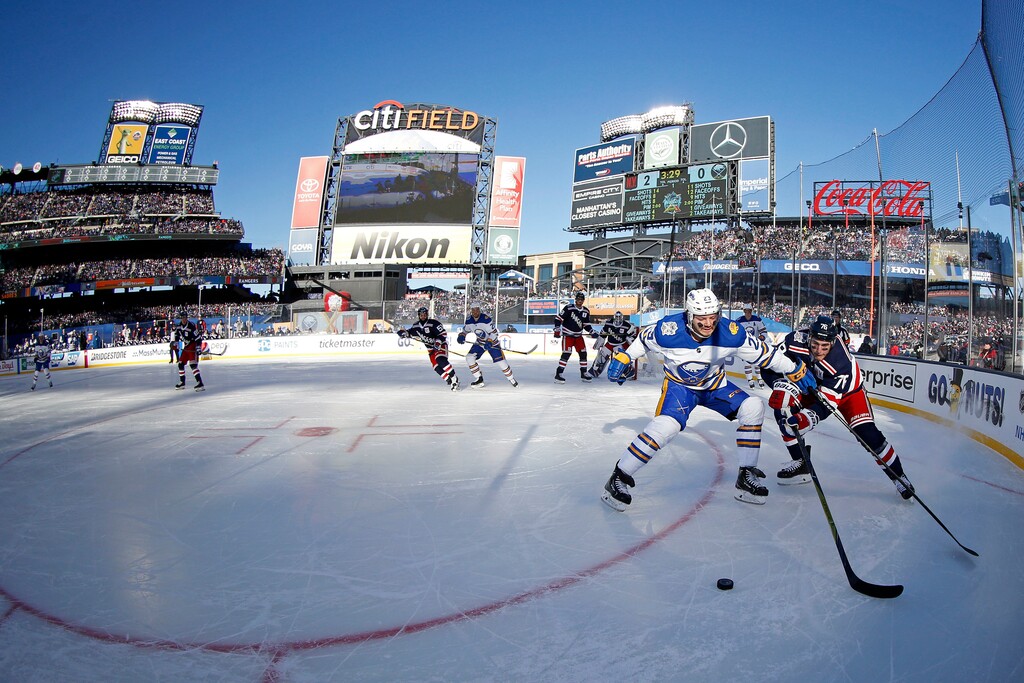 Buffalo Sabres center Sam Reinhart (23) battles for the puck with New York Rangers defenseman Brady Skjei (76) in the first period of the NHL Winter Classic hockey game at CitiField in New York on Monday, Jan. 1, 2018. (AP Photo/Adam Hunger)