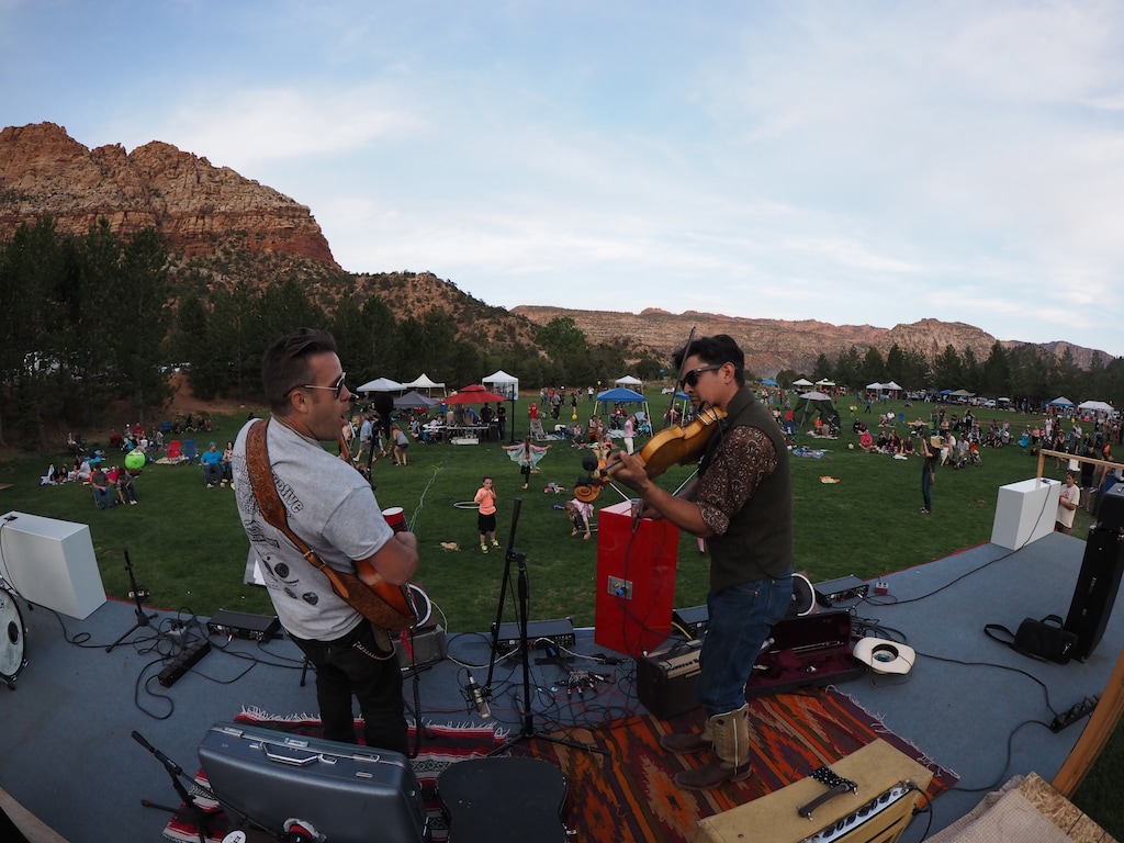 (Courtesy of Cracked Glass Photography) Colorado City Music Festival organizer Tom Bennett, left, plays with the fiddler known as Rooster during the 2018 festival.