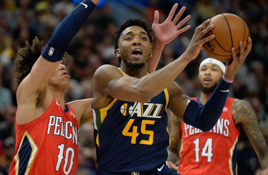(Francisco Kjolseth  |  The Salt Lake Tribune)  Utah Jazz guard Donovan Mitchell (45) pushes past New Orleans Pelicans center Jaxson Hayes (10) as the Utah Jazz host the New Orleans Pelicans in their NBA basketball game at Vivint Smart Home Arena in Salt Lake City on Sat. Nov. 23, 2019.
