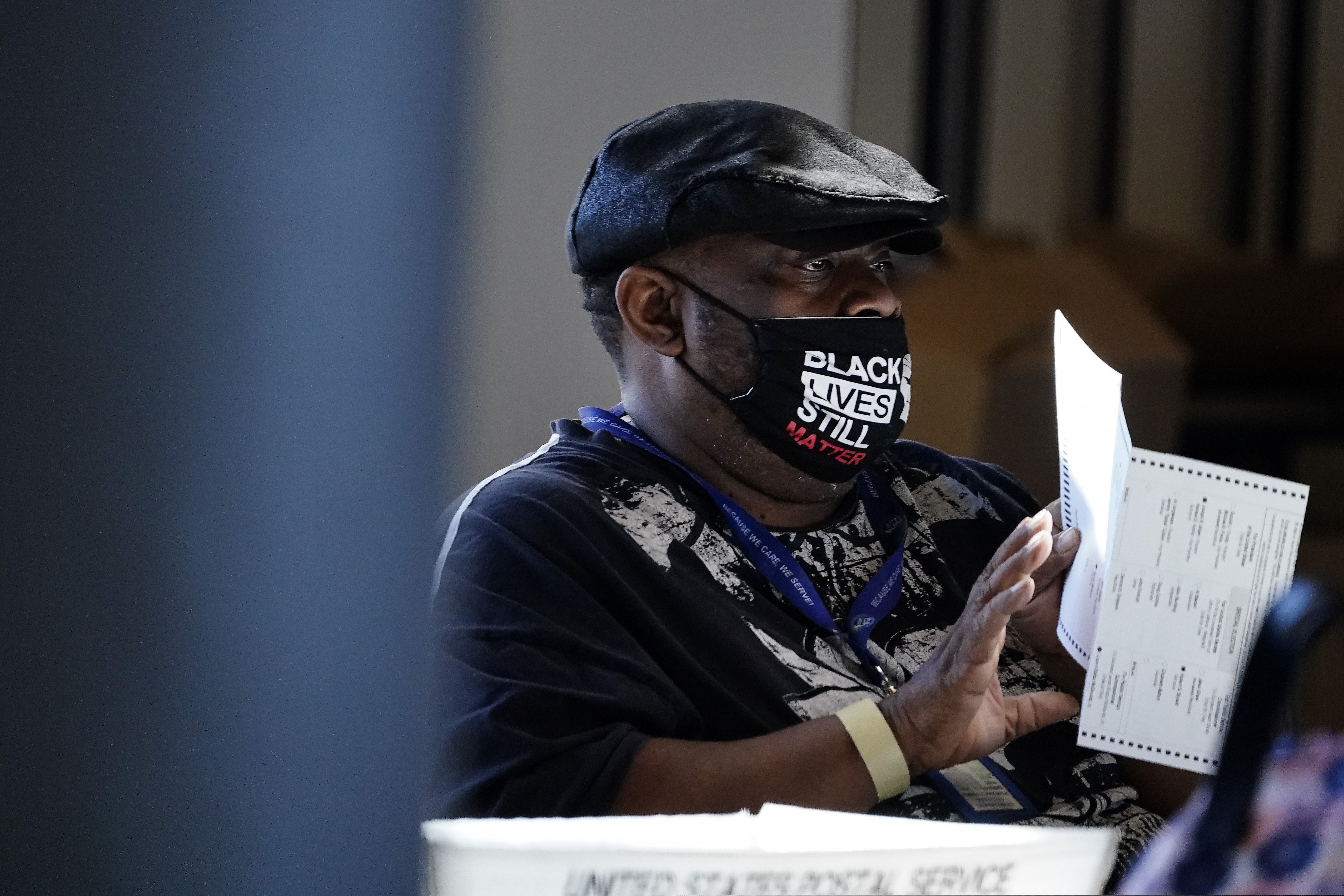 (Brynn Anderson | AP file photo)
In this Nov. 4, 2020, photo, an election worker holds a ballot as vote counting in the general election continues at State Farm Arena in Atlanta. President-elect Joe Biden won in Michigan, Wisconsin, Pennsylvania and Georgia because of Black voters, many of them concentrated in big cities.