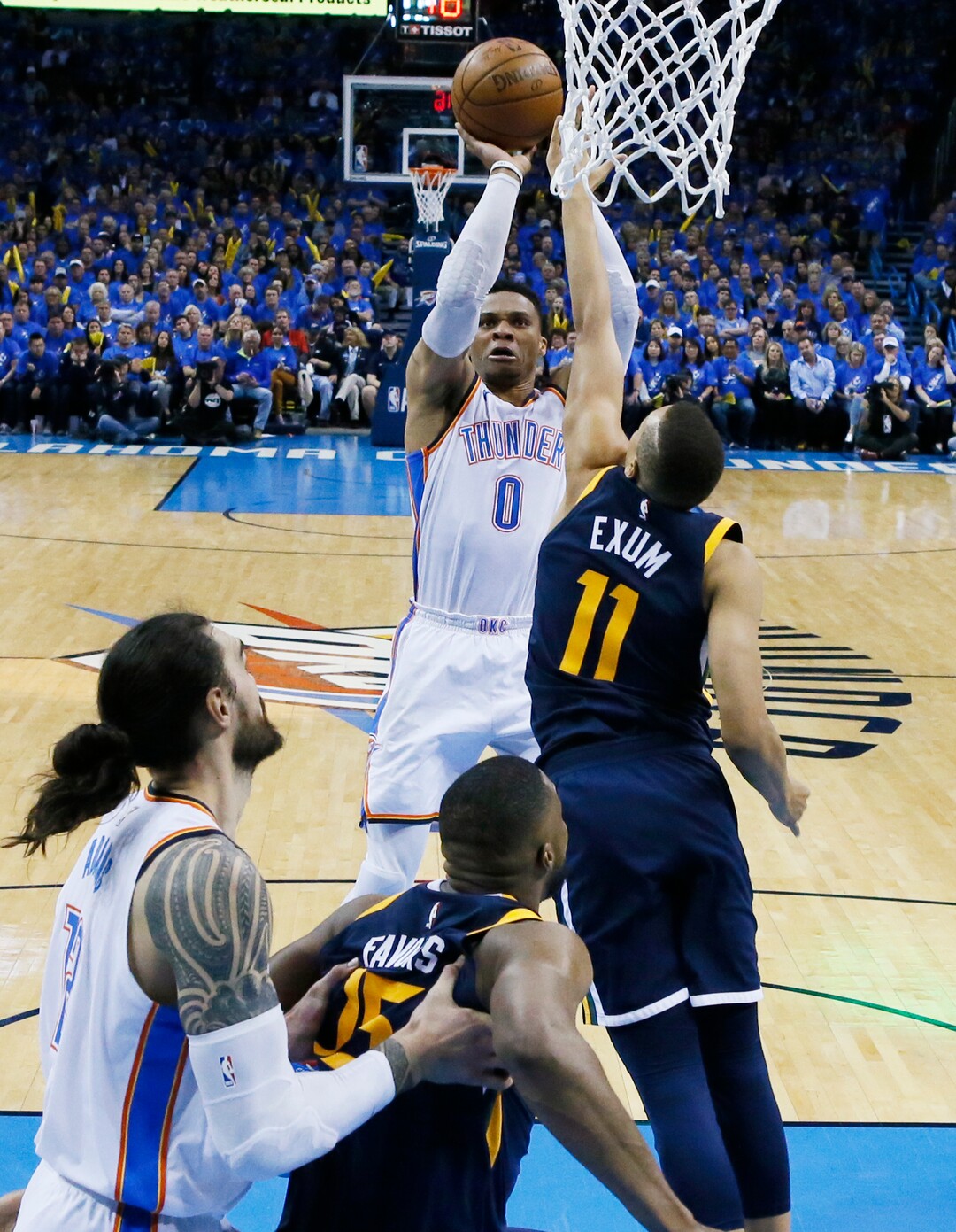 Oklahoma City Thunder guard Russell Westbrook (0) shoots as Utah Jazz guard Dante Exum (11) defends in the second half of Game 1 of an NBA basketball first-round playoff series in Oklahoma City, Sunday, April 15, 2018. (AP Photo/Sue Ogrocki)