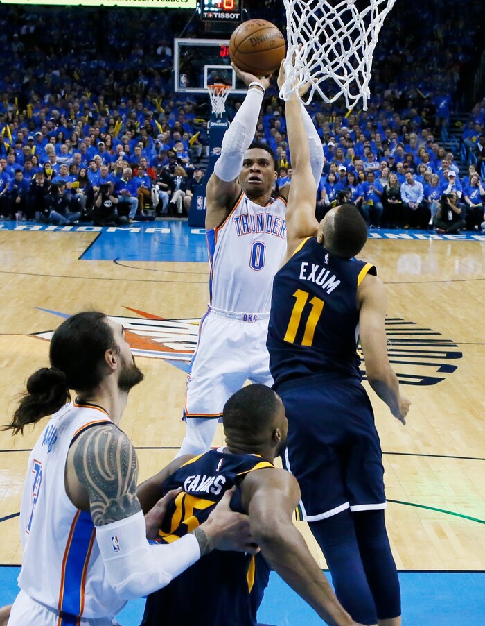 Oklahoma City Thunder guard Russell Westbrook (0) shoots as Utah Jazz guard Dante Exum (11) defends in the second half of Game 1 of an NBA basketball first-round playoff series in Oklahoma City, Sunday, April 15, 2018. (AP Photo/Sue Ogrocki)