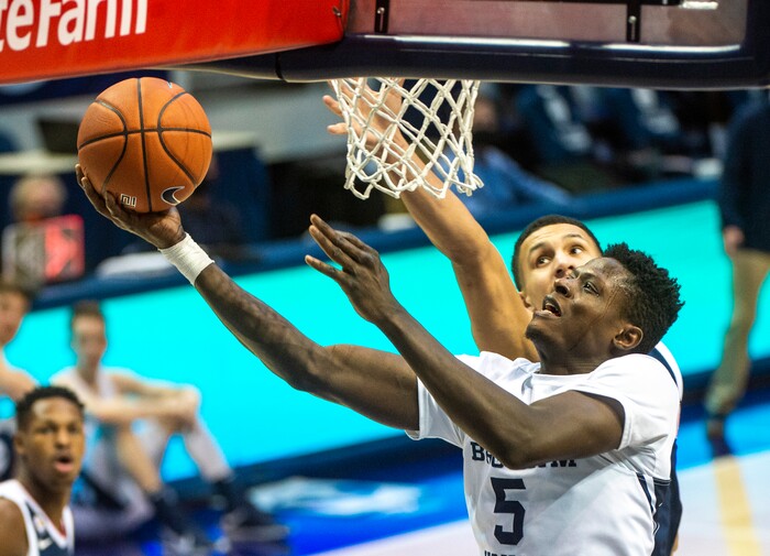(Rick Egan | The Salt Lake Tribune)  Brigham Young forward Gideon George (5) gets past Gonzaga Bulldogs guard Jalen Suggs (1) to score for the Cougars, in West Coast Conference Basketball action between the Brigham Young Cougars and the Gonzaga Bulldogs at the Marriott Center in Provo, on Monday, Feb. 8, 2021.