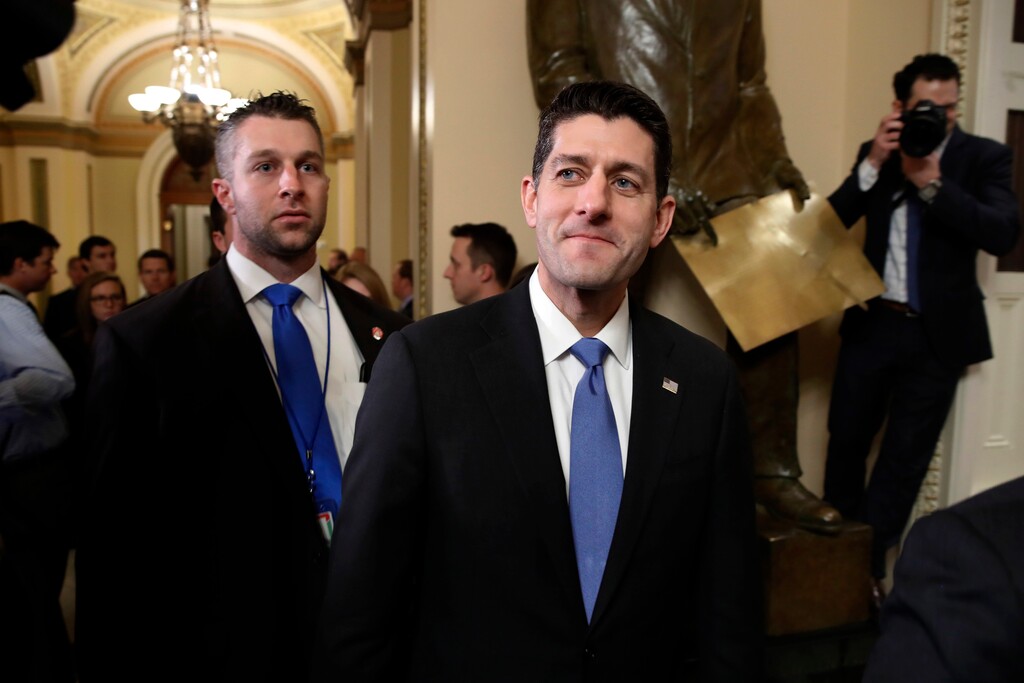 House Speaker Paul Ryan of Wis., center, leaves the House Chamber after voting on the Republican tax bill, Tuesday, Dec. 19, 2017, on Capitol Hill in Washington. Republicans muscled the most sweeping rewrite of the nation's tax laws in more than three decades through the House. (AP Photo/Jacquelyn Martin)