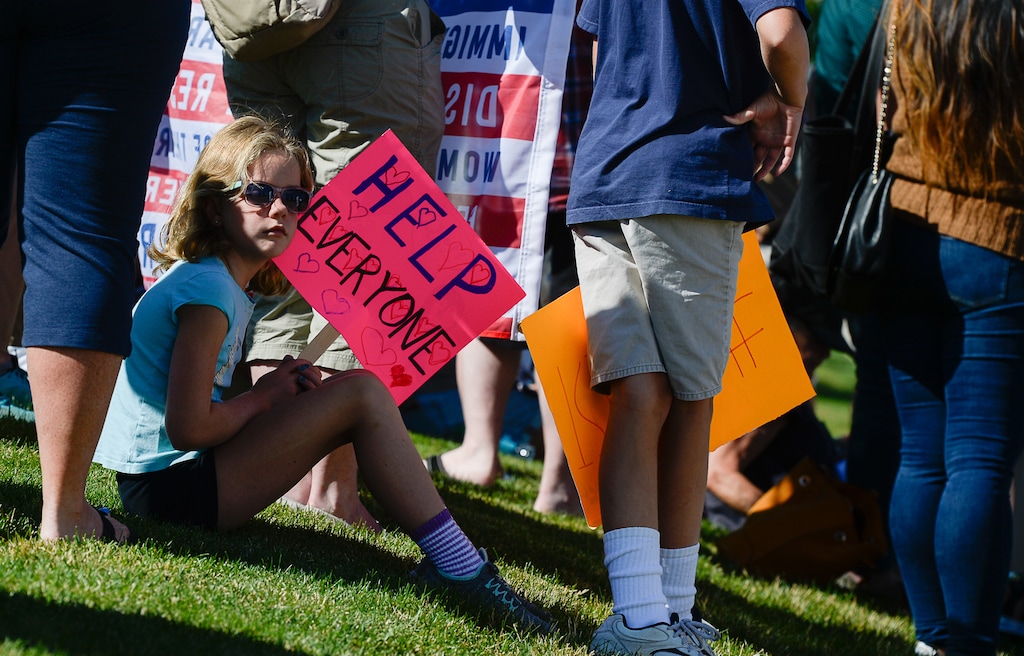 (Francisco Kjolseth | The Salt Lake Tribune) Claire Stradling, 7, joins her family along with Utah Jewish Community organizations, their members and friends as they gather outside of the U.S. Immigration and Customs Enforcement (ICE) field office at 2975 S. Decker Lake Drive, West Valley City, on Saturday, Aug. 10, 2019, for a Close The Camps vigil.