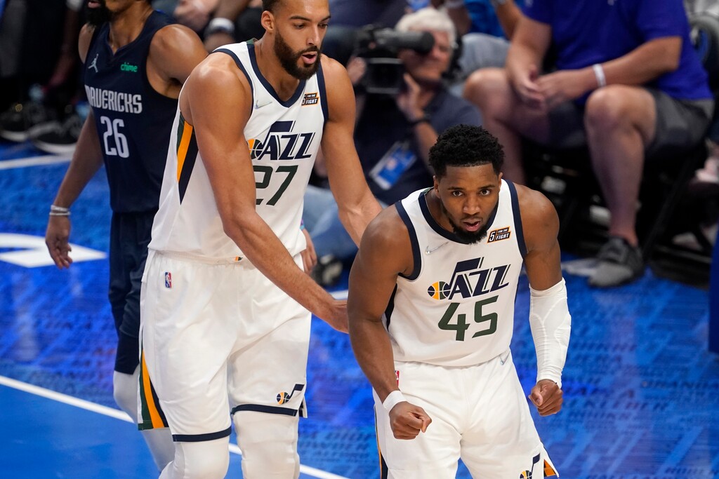 Utah Jazz's Rudy Gobert (27) and Donovan Mitchell (45) celebrate a basket by Mitchell in the second half of Game 1 of an NBA basketball first-round playoff series against the Dallas Mavericks, Saturday, April 16, 2022, in Dallas. (AP Photo/Tony Gutierrez)