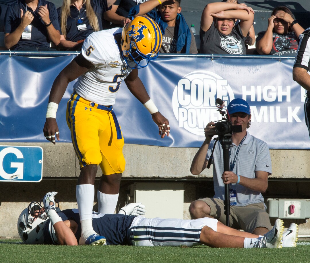 (Rick Egan  |  The Salt Lake Tribune)    Holker (32) lies on the ground after getting hit hard by McNeese State Cowboys defensive back Jovon Burriss (5). Burris was not called for targeting after the replay, in football action Brigham Young Cougars vs McNeese State Cowboys at Lavell Edwards Stadium, Saturday, Sept. 22, 2018.