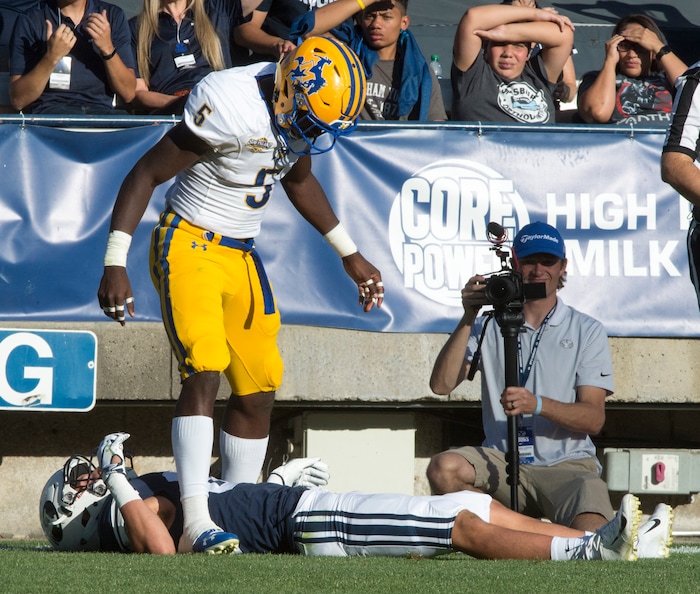 (Rick Egan  |  The Salt Lake Tribune)    Holker (32) lies on the ground after getting hit hard by McNeese State Cowboys defensive back Jovon Burriss (5). Burris was not called for targeting after the replay, in football action Brigham Young Cougars vs McNeese State Cowboys at Lavell Edwards Stadium, Saturday, Sept. 22, 2018.


