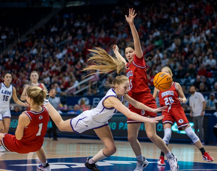 (Rick Egan | The Salt Lake Tribune) Lehi centerTara Smith (0) takes a tumble, she is fouled by Springville Red Devils, Ellie Esplin (1), in 5A State Championship game, at the Marriott Center in Provo, on Saturday, March 5, 2022. 
