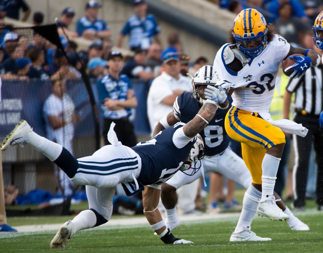 (Rick Egan  |  The Salt Lake Tribune)    Brigham Young Cougars linebacker Sione Takitaki (16) gets his hands on McNeese State Cowboys running back David Hamm (32), in football action Brigham Young Cougars vs McNeese State Cowboys at Lavell Edwards Stadium, Saturday, Sept. 22, 2018.