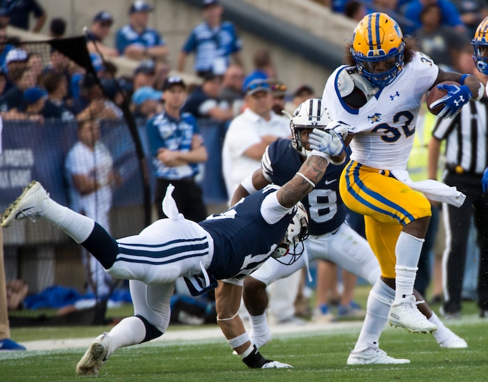 (Rick Egan  |  The Salt Lake Tribune)    Brigham Young Cougars linebacker Sione Takitaki (16) gets his hands on McNeese State Cowboys running back David Hamm (32), in football action Brigham Young Cougars vs McNeese State Cowboys at Lavell Edwards Stadium, Saturday, Sept. 22, 2018.


