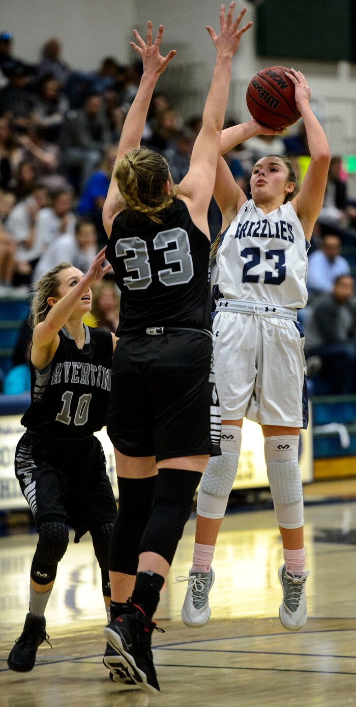 (Steve Griffin  |  The Salt Lake Tribune)  Copper Hills guard Breaunna Gillen fires a long three pointer over Riverton's Morgan Kane during the Riverton versus Copper Hills girl's basketball game at Cooper Hill s High School in West Jordan Thursday February 1, 2018.