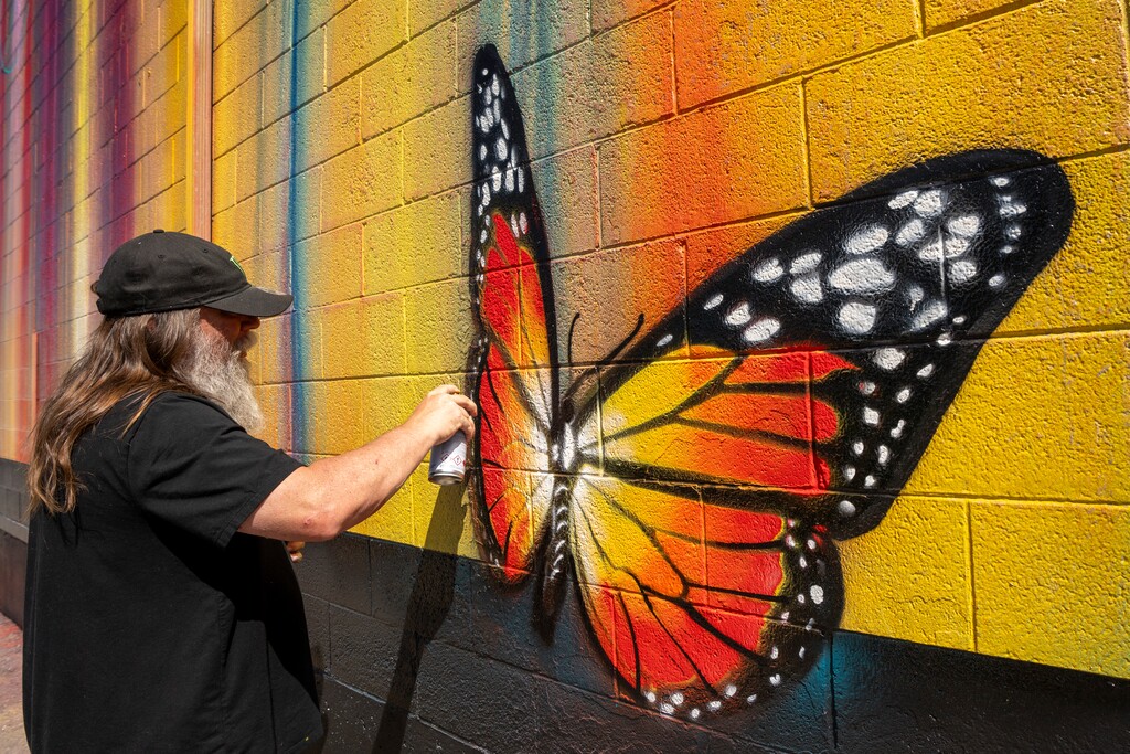 (Rick Egan | The Salt Lake Tribune) RISK puts the finishing touches on a his mural during the South Salt Lake Mural Fest, on Thursday, May 8, 2025.