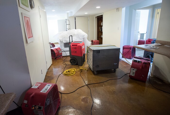 (Rick Egan  |  The Salt Lake Tribune)  Fans dry the basement of the Gisseman home, after the carpet and furniture were removed from the home on 2100 South. Tuesday, August 1, 2017.