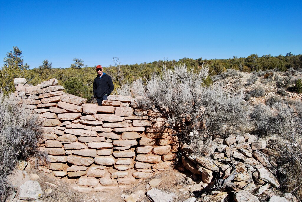 (Brian Maffly | The Salt Lake Tribune) Josh Ewing, executive director of Friends of Cedar Mesa, inspects the base of an 800-year-old tower that once stood over an Ancestral Puebloan settlement on Alkali Ridge east of Blanding. The Bureau of Land Management has issued numerous new oil and gas leases in the area, which is blanketed with artifacts — over the objections of historic preservation groups that fear the BLM lacks sufficient information about thousands of cultural sites to ensure their protection.