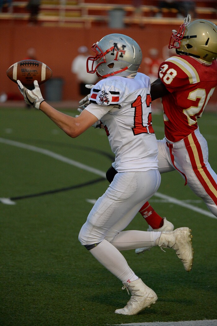 (Francisco Kjolseth  |  The Salt Lake Tribune)  Travis Thompson of Manti pulls in a long pass while pressured by  Fredrick Charles of Judge in the Class 3A football playoff game at Judge Memorial on Thursday, Oct. 19, 2017. 