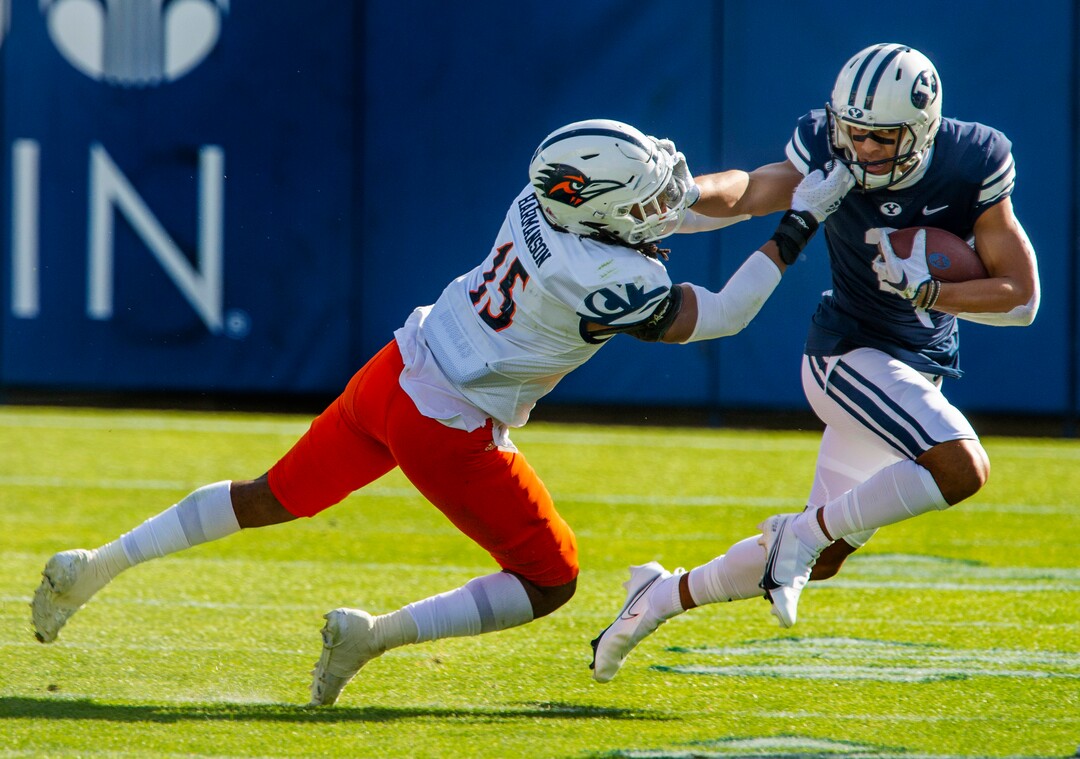 (Rick Egan  |  The Salt Lake Tribune)   Brigham Young wide receiver Neil Pau'u (2) runs the ball for the Cougars, as Roadrunners linebacker Trevor Harmanson (15) defends, in football action between the Brigham Young Cougars and the UTSA Roadrunners, at Lavell Edwards stadium, Saturday, Oct. 10, 2020.