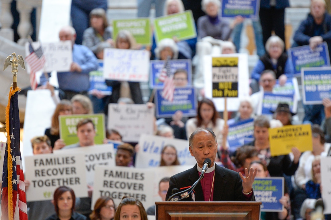 (Francisco Kjolseth  |  The Salt Lake Tribune)  Bishop Scott Hayashi, Episcopal bishop and original sponsor of the Prop 3 initiative takes to the podium on Monday, Jan, 28, 2019, in the Capitol rotunda on the first day of the Legislative session to rally in support of protecting Proposition 3, the Medicaid Expansion law recently passed by voters.