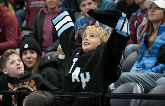 (Bethany Baker | The Salt Lake Tribune) A fan cheers during the game between the Utah Hockey Club and the Colorado Avalanche at the Delta Center in Salt Lake City on Thursday, Oct. 24, 2024.