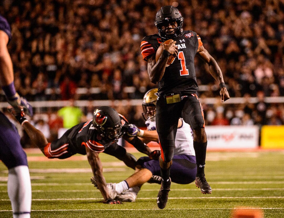 (Trent Nelson | The Salt Lake Tribune)  Utah Utes quarterback Tyler Huntley (1) runs the ball as the University of Utah hosts Washington at Rice-Eccles Stadium in Salt Lake City, Saturday Sept. 15, 2018.