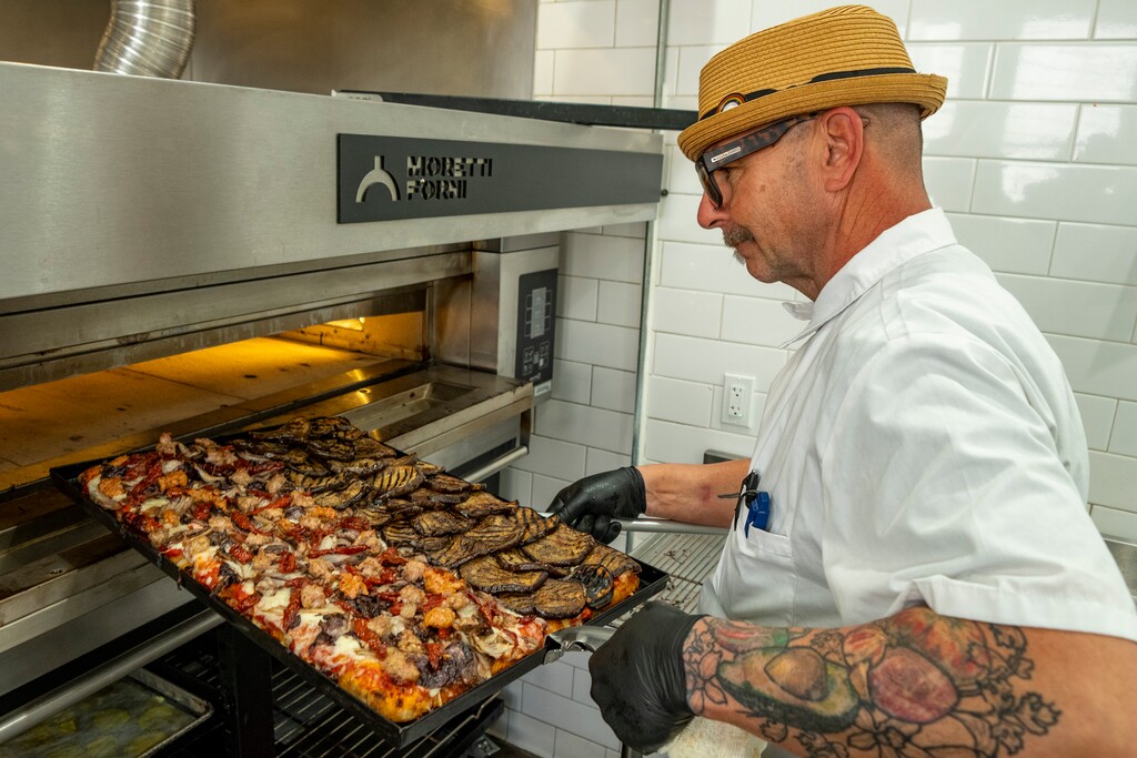 (Rick Egan | The Salt Lake Tribune)  Eric Davey cuts a slice of pizza at Via Veneto Pizzarium on Friday, April 24, 2026.